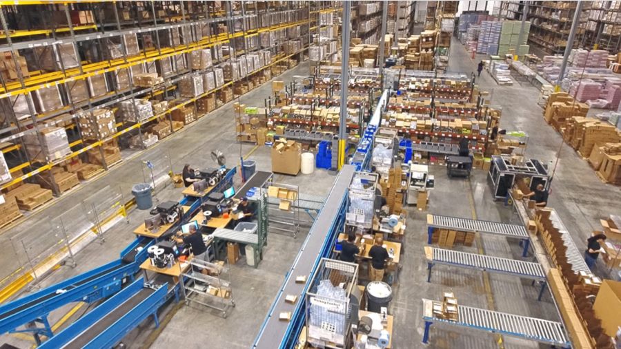 Modern fulfillment center with packing stations and automated storage systems